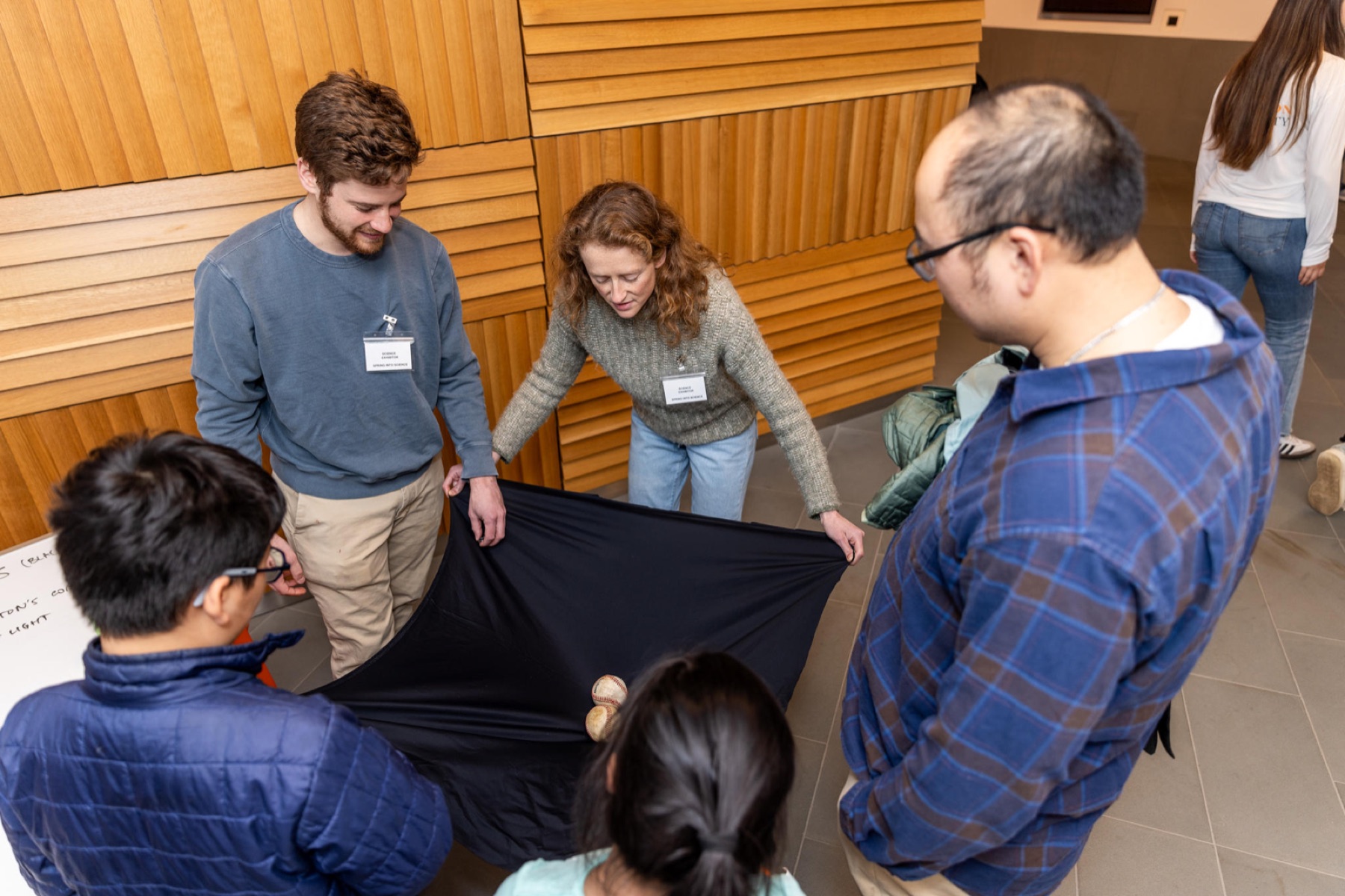 Spring Into Science visitors participating in a gravity demonstration
